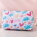 White canvas cosmetic bag with colorful floral prints and golden zipper detail - White Background Sunny Spring