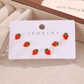 Three pairs of cute strawberry stud earrings with red enamel on a white jewelry card - Strawberry (WG-0828)