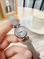 Silver mesh band watch with a minimalist round dial shown in a lifestyle setting - Silver Steel Mesh Strap