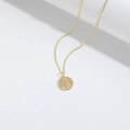 Elegant gold tree of life necklace with white zircon accents on white background - Tree of Life