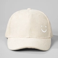 Close-up detail of beige corduroy baseball cap with white embroidered smiley face on side - Embroidered Smile / Beige