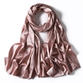 Detailed view of the smooth, lustrous texture of a pink satin scarf with soft folds - Honey Pink
