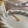 Minimalist gold titanium steel square necklace with a hollow letter Y pendant on a tray - Letter Y