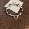 Detail view of grey pearl bracelet with zircon encrusted toggle clasp on fabric - Silver Round