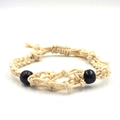 Detailed close-up of cream woven cotton cord necklace with black beads and mesh pouch - Bracelet / Off White