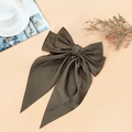 Elegant dark taupe satin oversized bow hair clip with long ribbons on pink background - Brown
