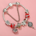Detail of silver-plated charm bracelet with red enamel heart and LOVE letter charms - Sl023318/1216-25