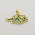 Macro detail of triceratops pendant with gold plating and green zircon micro-inlay - Green Zircon Triceratops