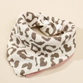 Detail showing soft four-layer cotton gauze baby bib with leopard print and snap closure - Leopard + Dusty Rose