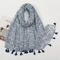 Detail view of navy blue floral scarf with tassels, styled with a magazine and dried plants - Artistic Dark Blue Floral Style (XB950)