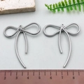 Silver bow hollow charms for jewelry making shown with size reference ruler - Long Rope Texture Bowknot - Silver (21397)