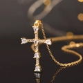 Golden cross necklace pendant with pear-cut zircon on a black reflective surface - Gold Pear-cut Main Stone Cross (款式40)