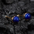 Macro shot of gold-plated S925 silver stud earrings with natural lapis lazuli on stone - Natural Lapis Lazuli Round Gold 5mm