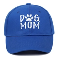 Detailed view of white DOG MOM embroidery and paw print on navy cotton baseball cap - Blue