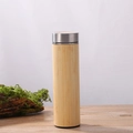 Insulated bamboo water bottle with a sleek metal lid placed on a wooden desk surface - 450ml Bamboo Shell Straight Cup