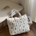 Detail der weißen gesteppten Handtasche mit Bärenmuster und Simple Wish Aufnäher - Gestreifter Bär