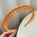 Non-slip wavy orange hairband with teeth made of matte plastic for daily use - Yellow