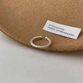 Minimalist silver twist open ring with black onyx detail on a cork tray display - JZ0137 (Twisted Texture)