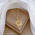 Close-up of gold star and heart pendant necklace with rhinestones on silk fabric - Gold Heart & Star Style (G514)