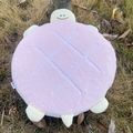 Close-up of pink turtle shell plush cushion with cute face on green grass background - 40CM / Pink Turtle