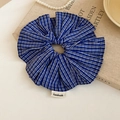 Detail of blue plaid fabric scrunchie with handmade label on vintage book background - Blue Plaid Scrunchie
