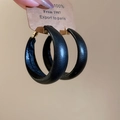 Minimalist black leather hoop earrings with gold metal accents on display card - Black