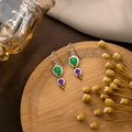Detailed view of vintage silver earrings with green and purple gems on a wooden tray - E5850-Antique Silver Green Purple Two-Tone Gemstone