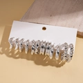 Detailweergave van zilveren oorringenset met verschillende texturen op een kaart - Zilver (12-delige set)