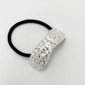 Detailed view of silver metallic ornament with irregular texture on black elastic hair tie - Sand Silver Type 2