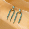 Macro detail of long tassel earrings with blue crystals on orange silk background - Gold Blue (NMSE-C245-3)