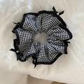 Detail of checkered scrunchie with black ruffled edges and white pearl accent - Black Pearl Style
