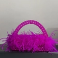 Close-up of fuchsia beaded evening bag featuring luxurious ostrich feather accents - New Rose Red