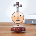 Miniature wooden Ruan lute music box with realistic grain and metal strings on desk - Moon Lute Music Box