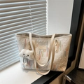 White quilted canvas tote bag with colorful embroidery and a plush cloud charm - White