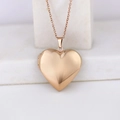 Rose gold heart-shaped locket necklace with polished finish on a white stone stand - Smooth Heart 29*29/Rose Gold