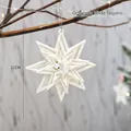 Sparkly 11cm white glitter star ornament hanging on a Christmas tree with warm lights - Octagram (White Sequin)