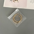 Golden metal hoop earrings in transparent EVA jewelry packaging bag for storage - 50 Silk Transparent Zipper Bag / 8x8cm