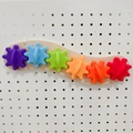 Rainbow wooden busy board accessory with six colorful gears and a wavy timber base - Blank Wave Gear Set