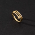 Macro view of gold-plated nail ring featuring sparkling zircon stones on black background - Gold Nail Micro-inlay Style