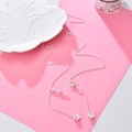 Silver eyewear chain featuring floral pendants and clear crystal accents on white ceramic - Flower / Silver