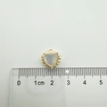Detail view of 18K gold-plated heart pendant with white shell inlay next to a metric ruler - Beaded Border Style / Gold Beaded Border Heart (White Shell)