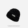Fuzzy black knit beanie in soft faux fur plush with a woven textile brand label - Metal Label Style / Black