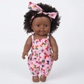 Close-up of 12-inch African American baby doll with curly hair and pink butterfly outfit - Pink Butterfly Tie-Dye