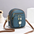 Blue mini crossbody bag with litchi texture leather and cute golden cat charm - Blue