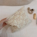 Detail of cream quilted makeup bag featuring red embroidered rabbits and woven label - White with Red Rabbit