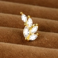Detailed close-up of a golden leaf earring with zircon stones on brown velvet - Y20411-15 Gold 0.8mm