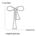 Elegant silver bow brooch with sparkling rhinestones and dangling fringe tassel style - Silver