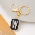 Macro detail of golden letter W keychain with sparkling rhinestones and lobster clasp - Letter W