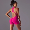 Detail view of pink one-piece yoga romper featuring back cutout and scrunch butt design - S / Top And Bottom / Dragon Fruit