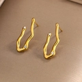 Detail of gold irregular wave earrings featuring embedded zircons on a textured surface - Gold Irregular Wave White Zircon (E-221)